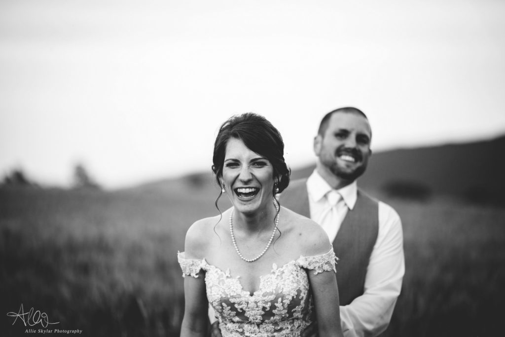 bride and groom in a field at the barn at hidden acres in bloomsburg pa