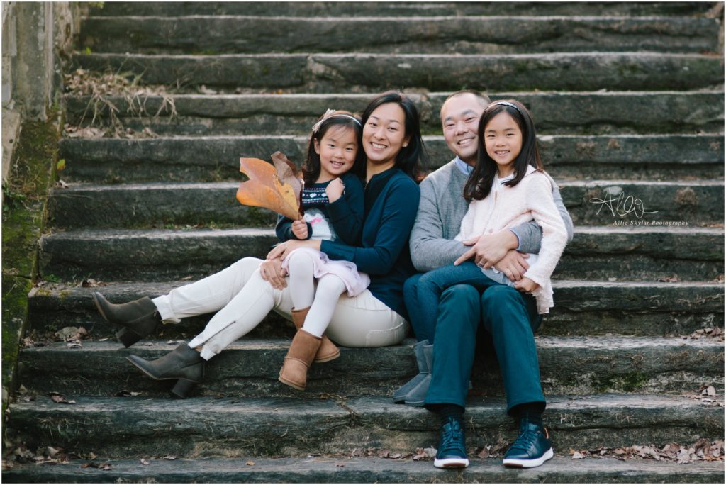 family sits on stone steps at ridley creek state park 