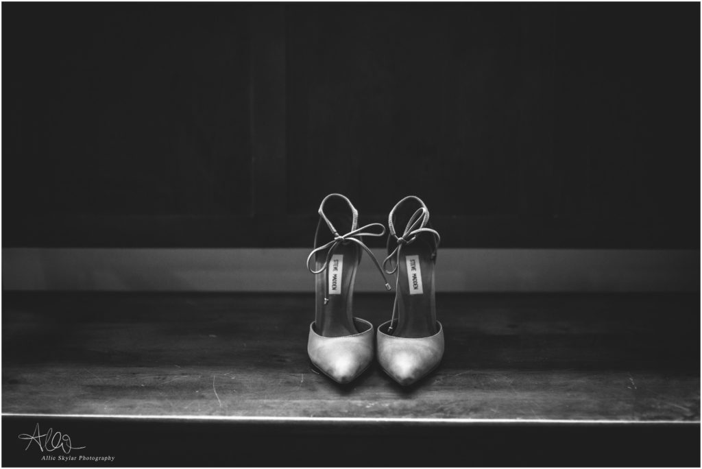 black and white photo of brides shoes