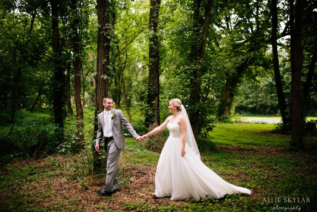 bride and groom walk in the woods by Rupert Bridge in Bloomsburg PA