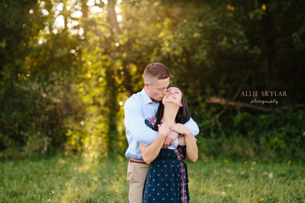 engaged couple embrace in the sunset during their farm engagement session in bloomsburg PA