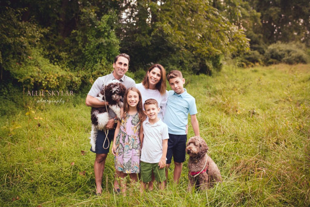 family-pose-with-dogs-for-family-photo-at-ridley-creek-state-park