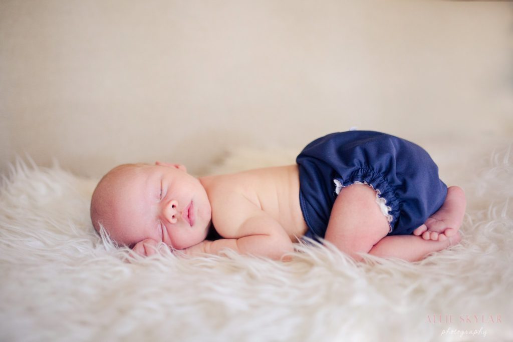 newborn-baby-boy-posed-on-antique-sofa