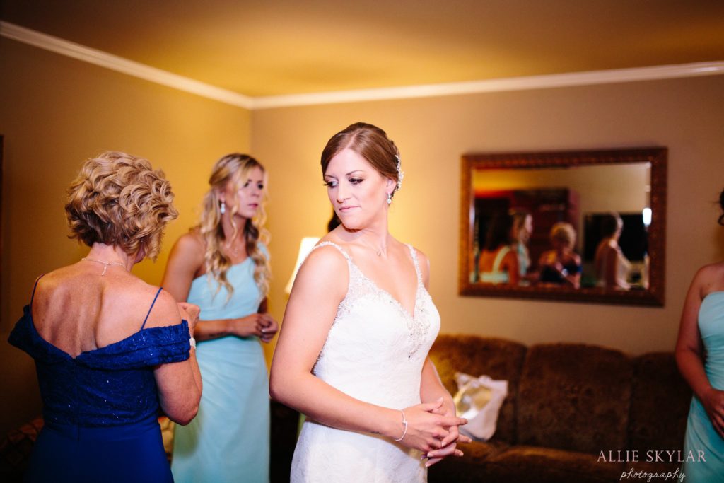 bride puts on her wedding dress in her suite at the pine barn inn in danville pa