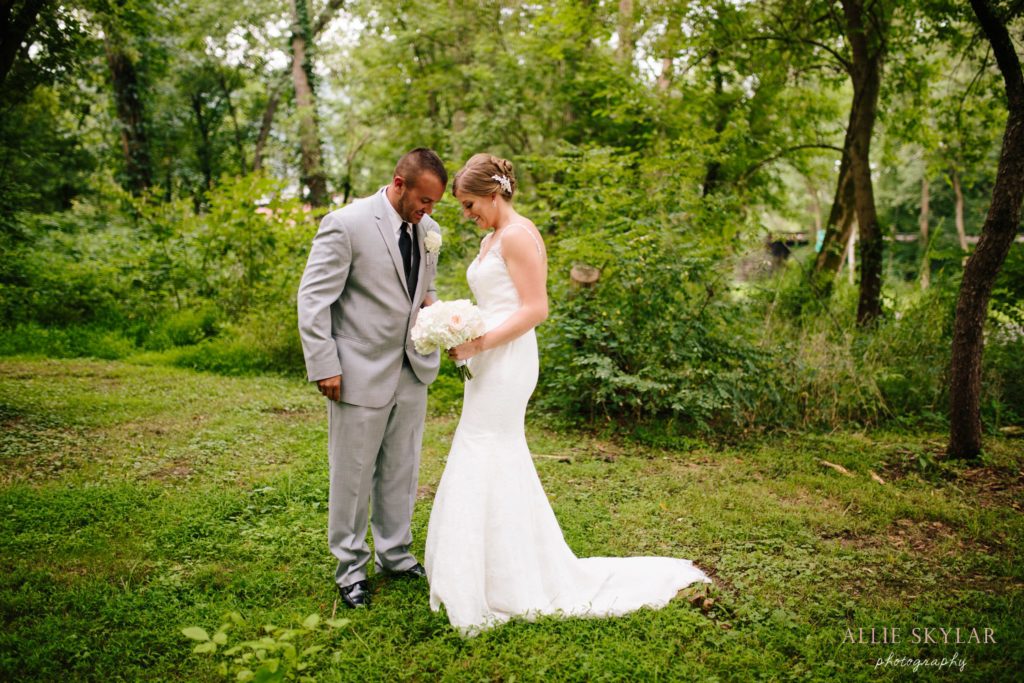 bride and groom embrace in the woods along the Susquehanna river in Bloomsburg PA