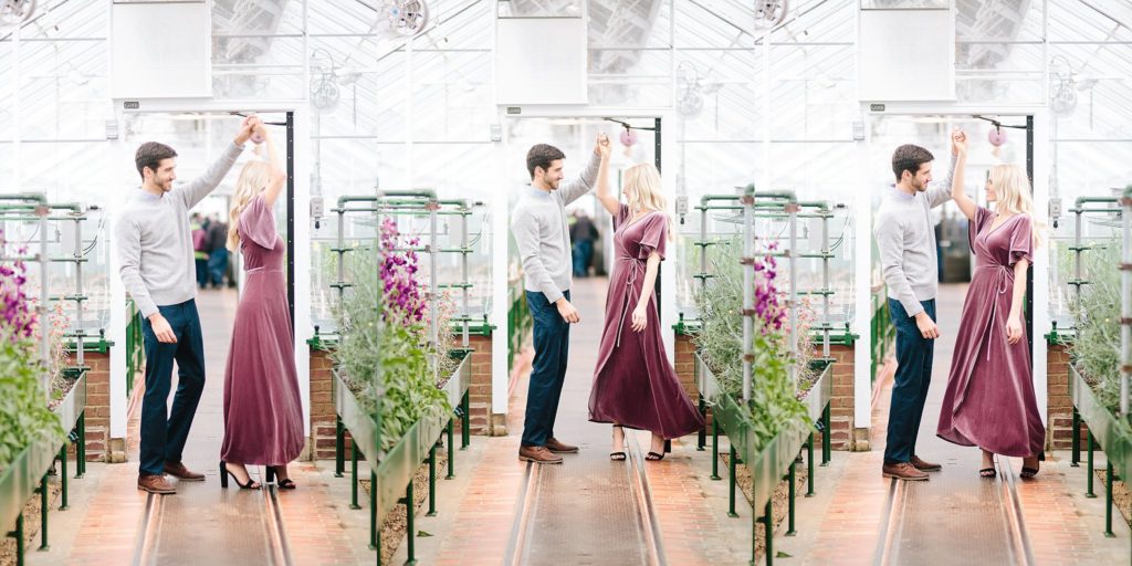 engaged couple dance in the greenhouses at Longwood Gardens during their engagement session