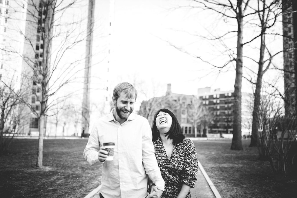 couple walk and laugh on the campus of Penn University in philadelphia pennsylvania
