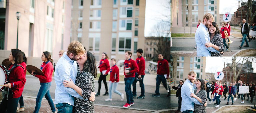 couple kiss while surrounded by a marching band at Penn University in Philadelphia Pennsylvania
