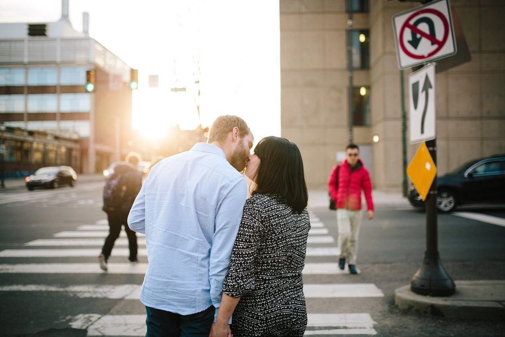 couple kiss as the sun goes down in Philadelphia Pennsylvania for their engagement session