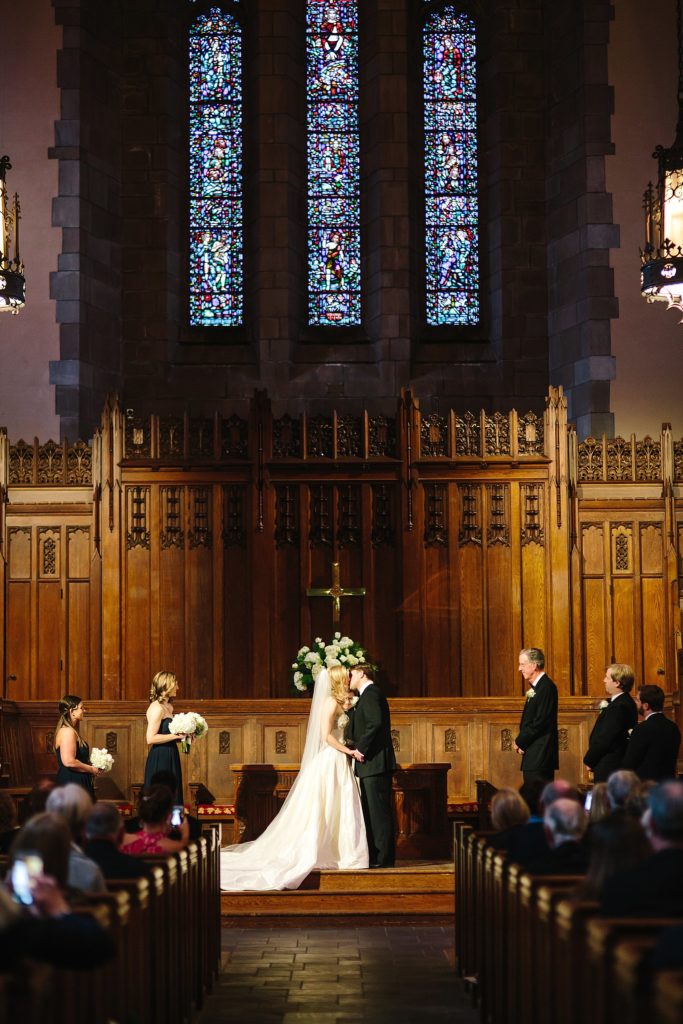 bride and groom kiss during their elegant wedding at Bryn Mawr Presbyterian church on the main line