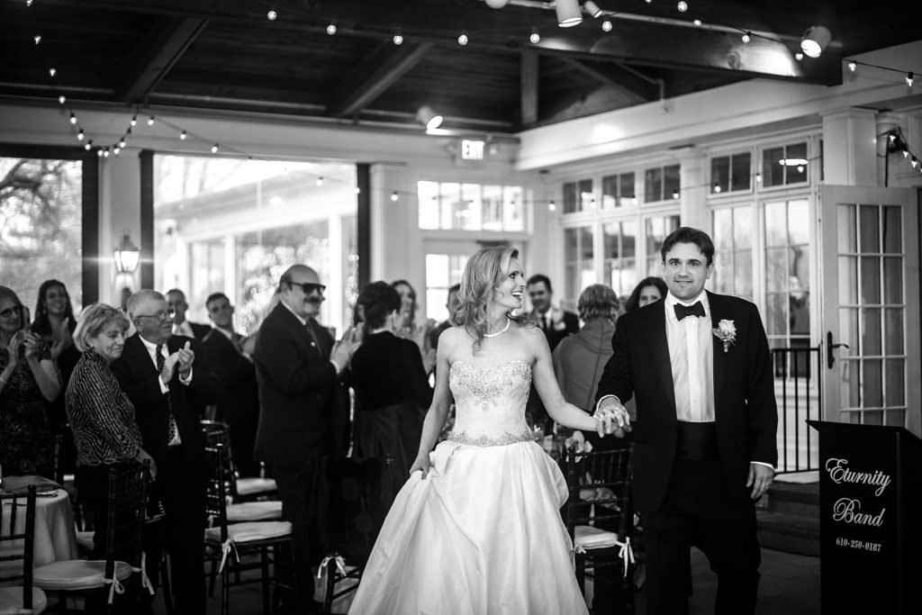 bride and groom enter their reception at Gulph Mills Golf Club in Philadelphia PA