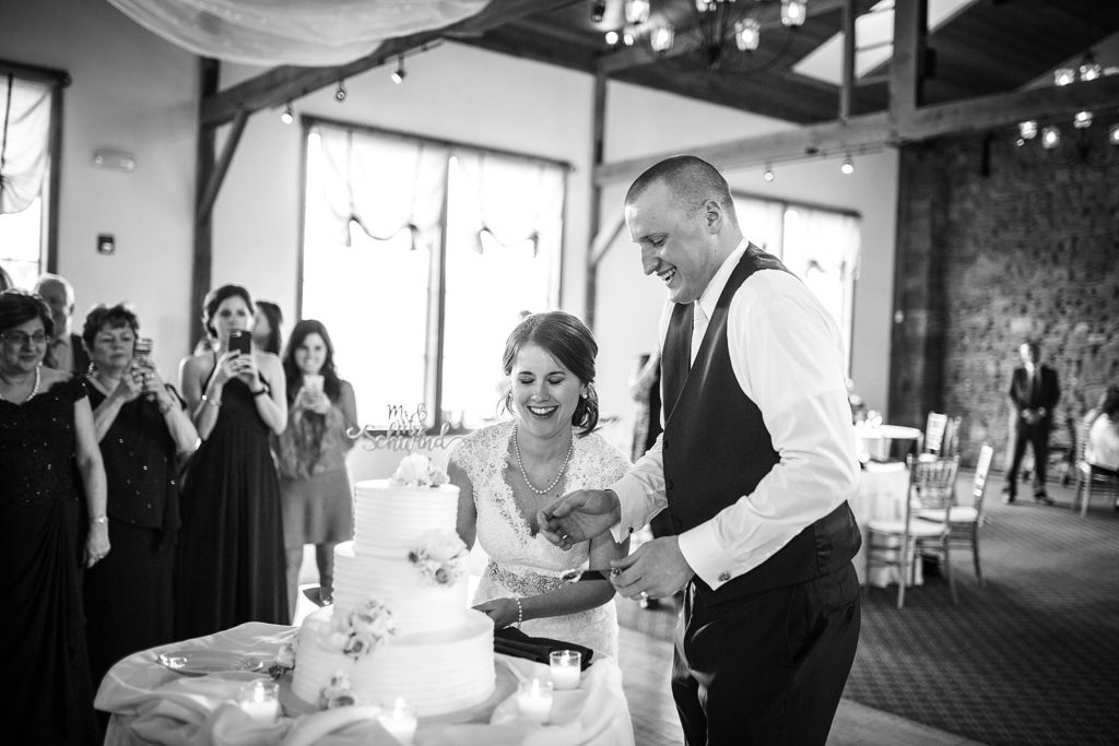 bride and groom cut cake at wedding at la massaria at bella vista