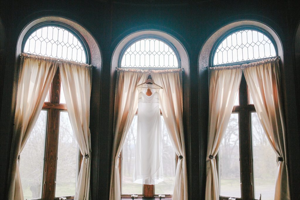 brides wedding dress hanging in old estate in Ambler PA