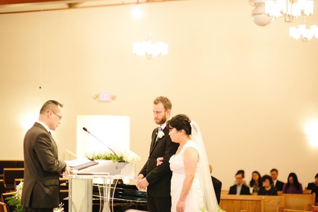 bride and groom are married in a korean american wedding at first korean Presbyterian church of Philadelphia