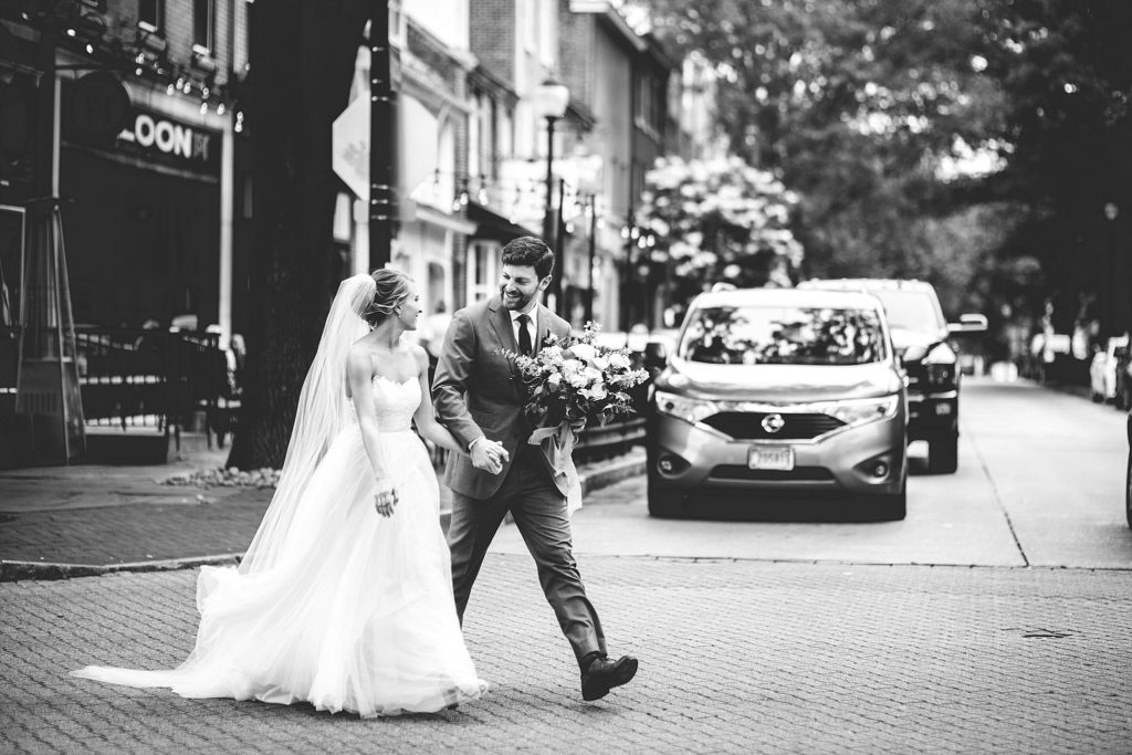 bride and groom run through the streets of west chester pennsylvania