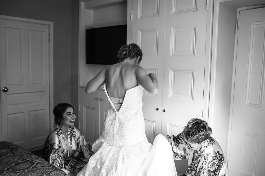 bride get's into her wedding dress at Grace Winery in Glen Mills PA