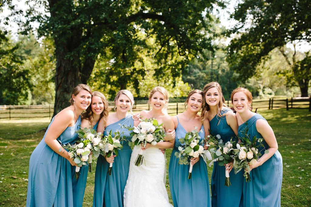 bride and bridesmaids share some laughs at Grace Winery