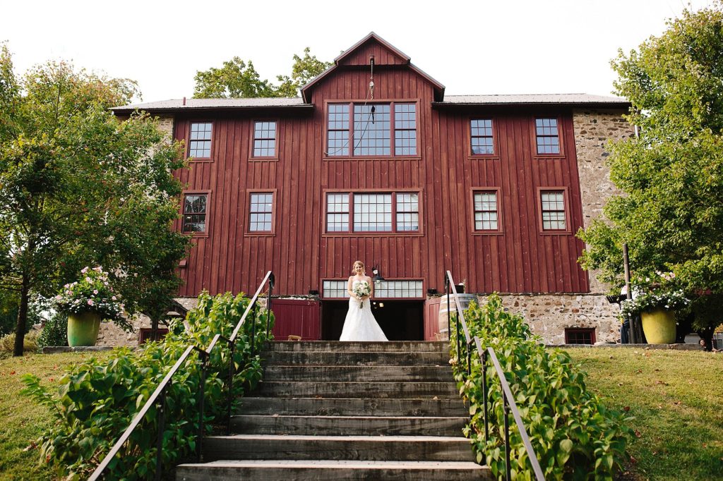 bride walks down the aisle at GRace Winery in GLen Mills, PA
