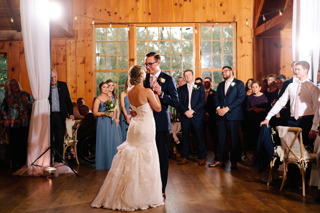 bride and groom share their first dance in the barn at Grace Winery