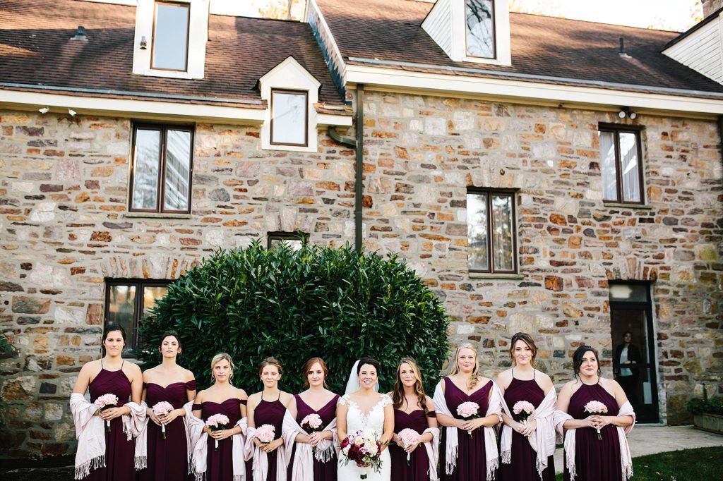 The Manor at Prophecy Creek Wedding bridesmaids pose in front of manor in blue bell pa