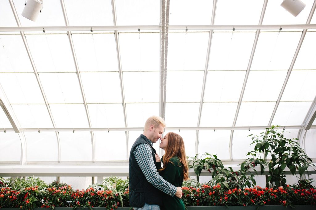 engaged couple pose at longwood gardens during their engagement session