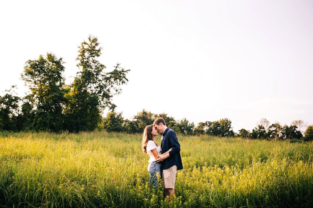 couple stand in a field at Jacosburg State Park during their engagement session