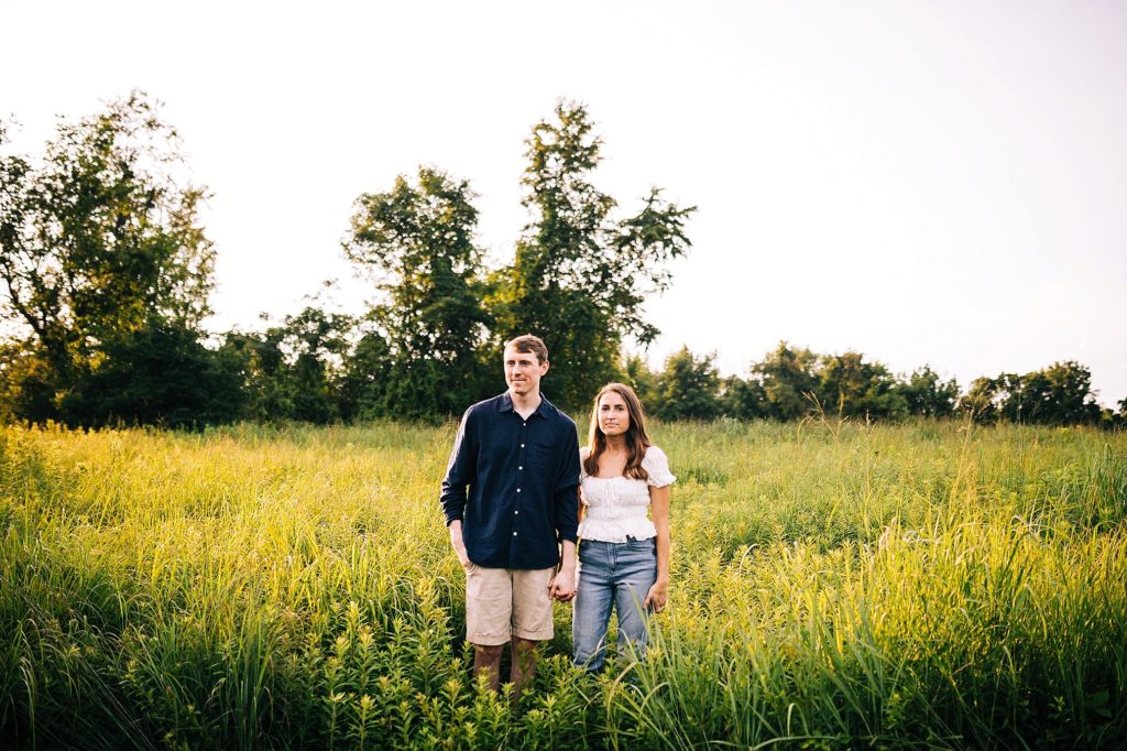 couple stand in a field at Jacosburg State Park during their engagement session