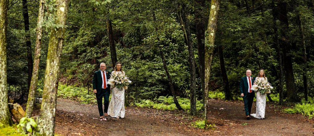 bride walks through the forest during her wedding at pump house b&b