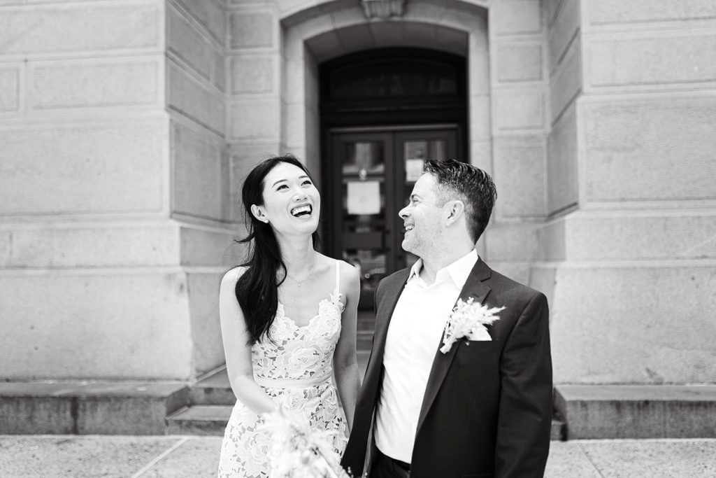 couple laugh outside of city hall after their Philadelphia elopement