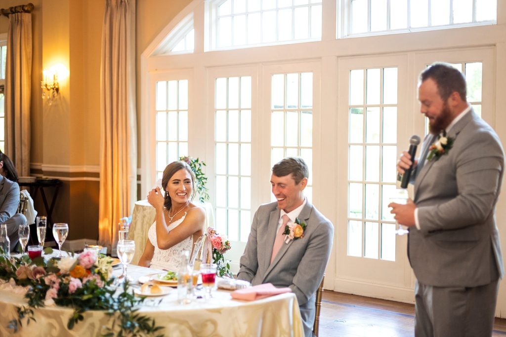 bride and groom listen to toasts during their wedding reception at Pen Ryn state in the Belle Voir Manor