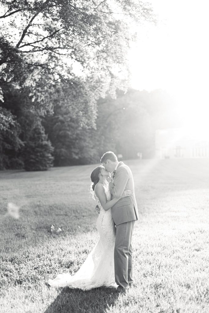 bride and groom kiss during sunset at Pen Ryn Estate in Bucks County