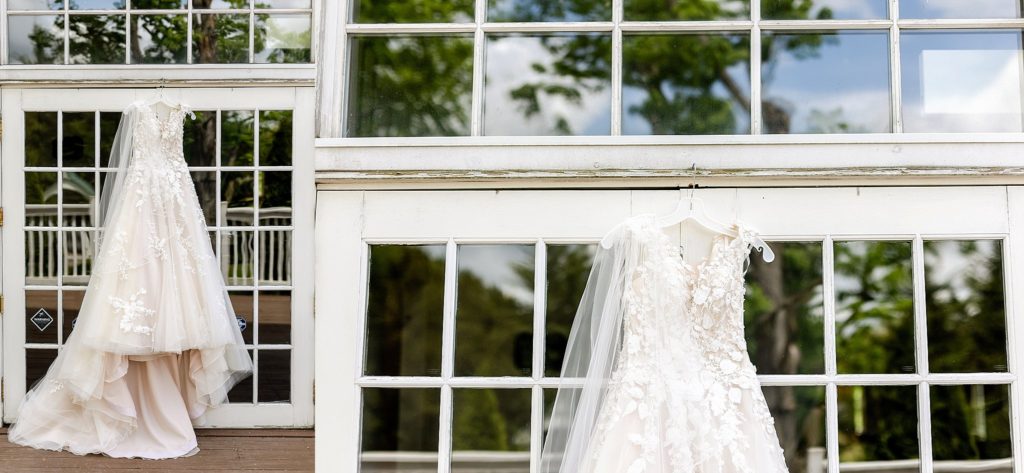 Bride's wedding dress hangs outside the barn at boones dam