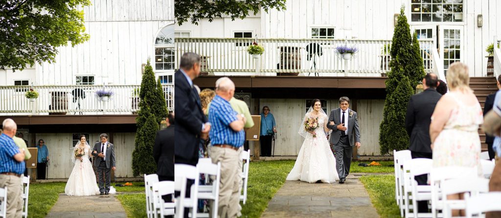 bride walks down the aisle towards her groom at the barn at boones dam in bloomsburg PA