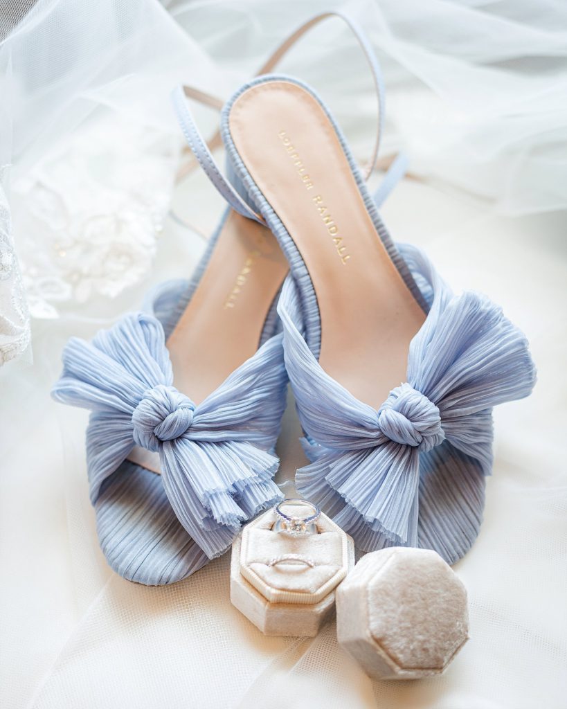 Light blue bridal Loeffler Randall Shoes are styled on the bride's dress