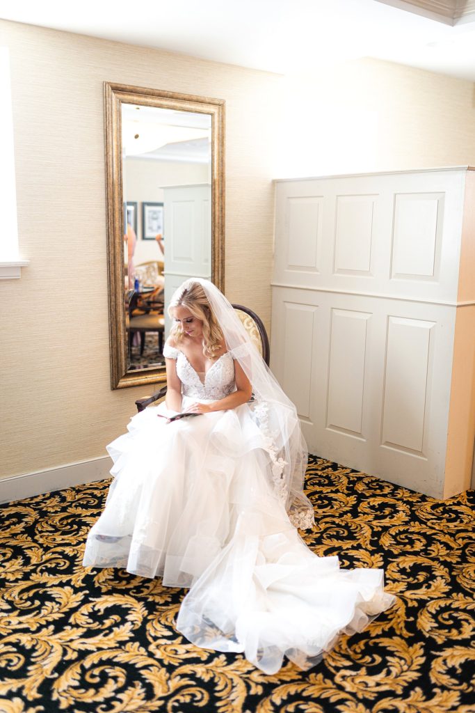 bride reads groom's vows in the bridal suite at william penn inn