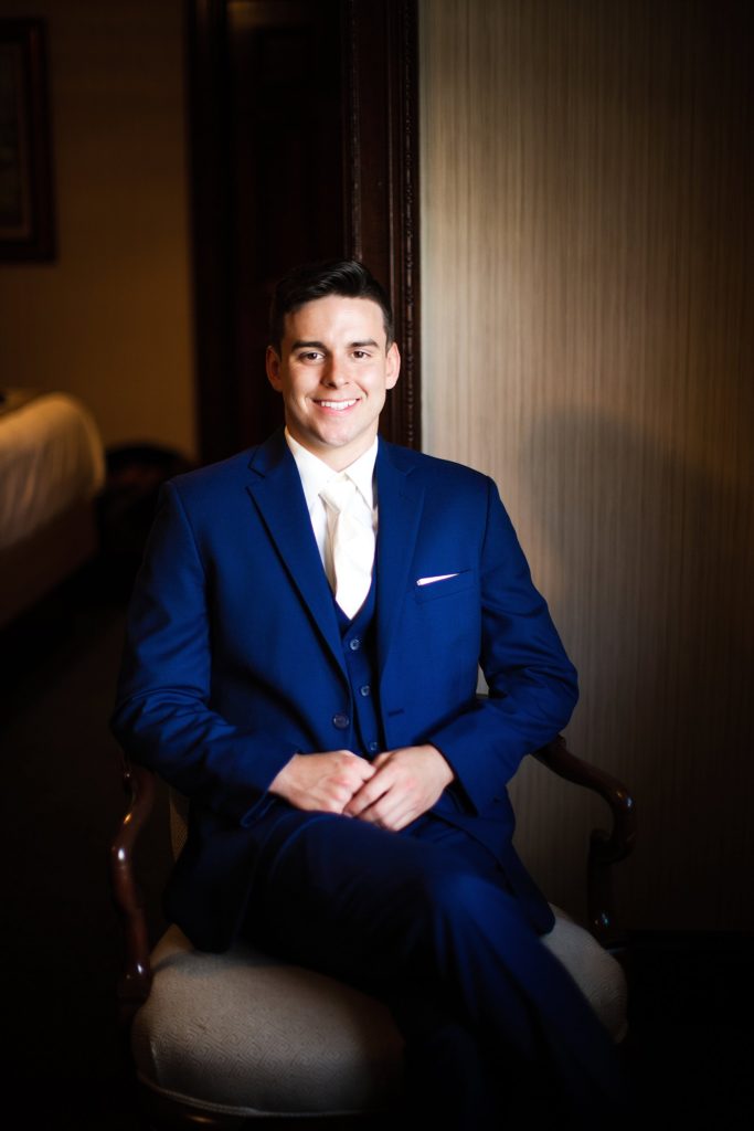groom poses in his suite at the william penn inn
