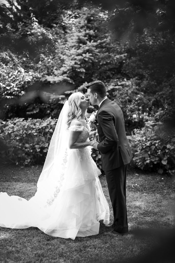 bride and groom kiss during their first look at the William Penn Inn