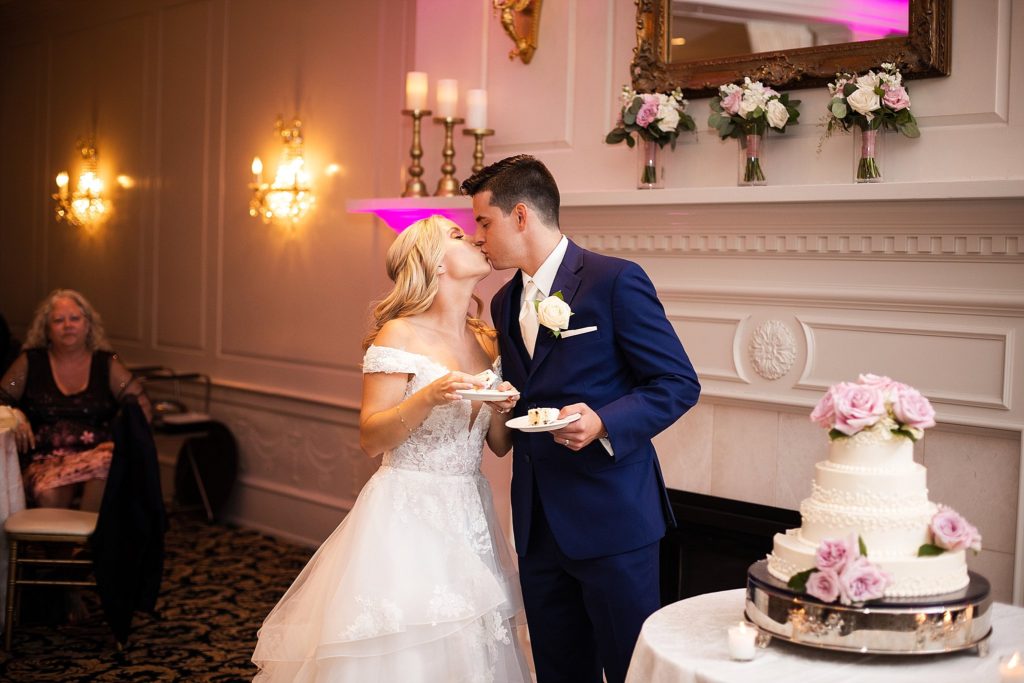 bride and groom cut their cake during their wedding reception at william penn inn